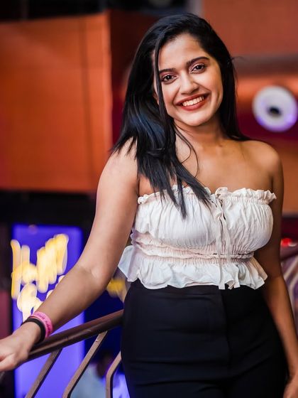 A guest smiling on the balcony, enjoying the party from a different perspective.