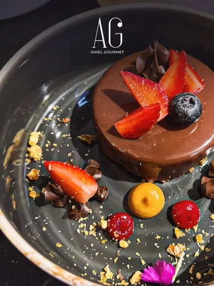 A glimpse of a dessert from one of our recent catering events. This chocolate mousse cake is decorated with fresh berries and edible flowers, making it as beautiful as it is delicious.