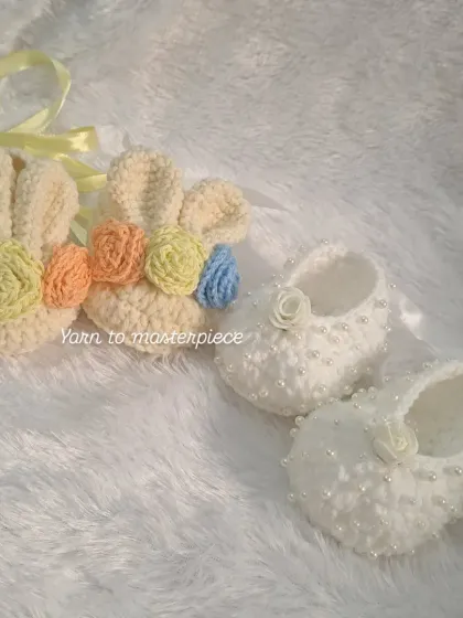 This image shows two different styles of my embellished booties: one with colorful bunny ears and flowers, and the other with classic white pearls and a rose.