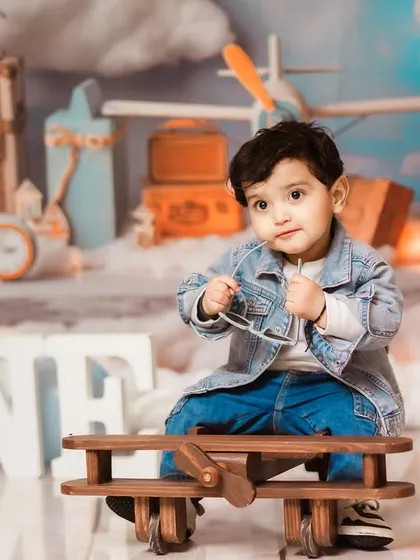 To a year of navigating all the firsts. I love creating conceptual pre-birthday shoots like this vintage pilot theme, complete with a wooden airplane prop and a sky backdrop, to tell your baby's unique story.