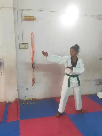 A female student demonstrates her Poomsae during a belt test. We focus on correct form and technique for all our students.