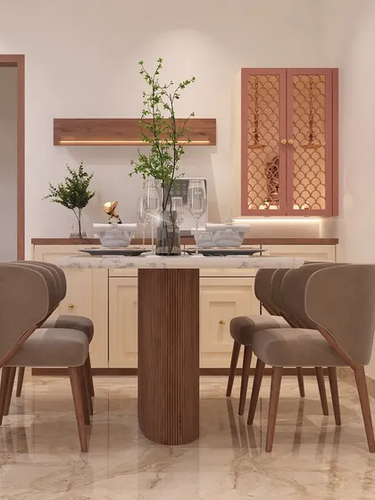 This dining setup is perfect for intimate meals and good conversations. The round pedestal table encourages interaction, and the curved, upholstered chairs provide exceptional comfort. The pink crockery unit adds a pop of color.