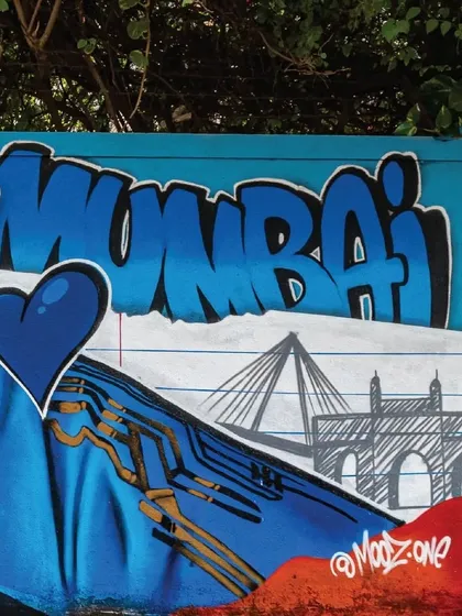 A detailed shot of the "Mumbai" graffiti tag next to the Kieron Pollard mural, featuring sketches of the Bandra-Worli Sea Link and Gateway of India, connecting the player to the city he represents.