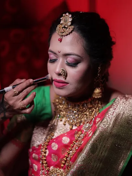 A behind-the-scenes moment of applying blush to a bride. This demonstrates the hands-on techniques I teach for achieving a flawless, long-lasting finish, ensuring the makeup looks perfect both in person and in photos.