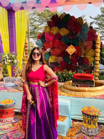 A full view of my vibrant lehenga for a daytime Haldi function. The colourful decor inspires my look.