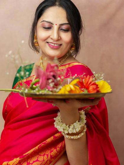 This mother-to-be wanted to incorporate cultural elements into her studio maternity session. Holding a thali of flowers, her gentle smile radiates a sense of peace and celebration.