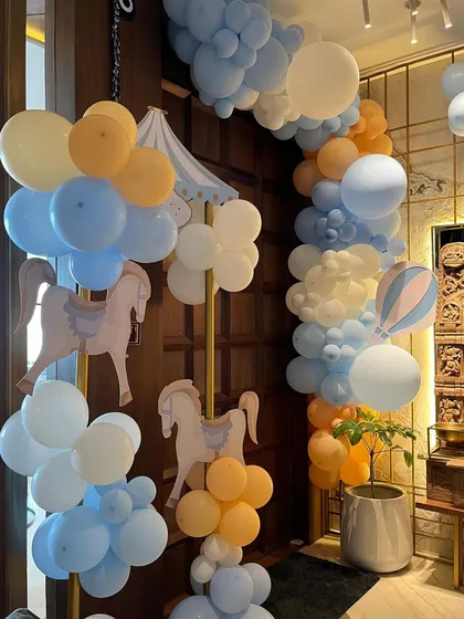 The whimsical theme extended to the entrance, with a beautiful balloon arch and hanging carousel horse cutouts to welcome guests into the celebration.