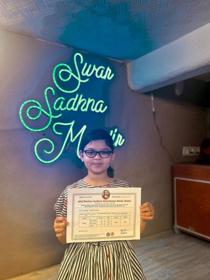 A young student with her first music exam certificate. We nurture talent from a very young age, setting them on a path to musical excellence.