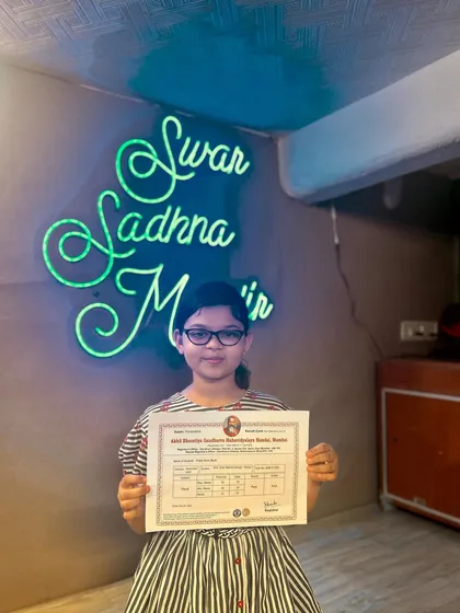 A young student with her first music exam certificate. We nurture talent from a very young age, setting them on a path to musical excellence.