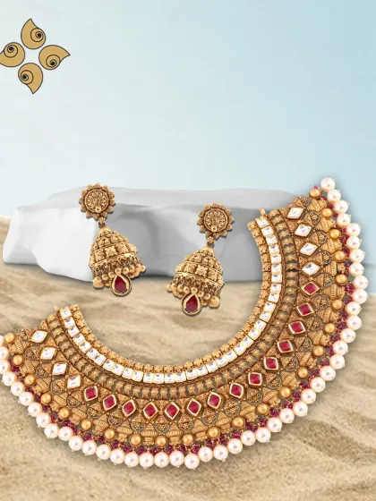 When the moment is golden, your jewellery should be too. This antique-finish choker set with red and white stones is designed to dazzle and is a popular choice for festive and wedding seasons.