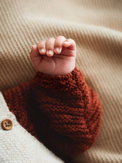 A macro shot of a newborn's tiny, perfect hand. The details, from the little fingernails to the soft skin, are worth preserving.