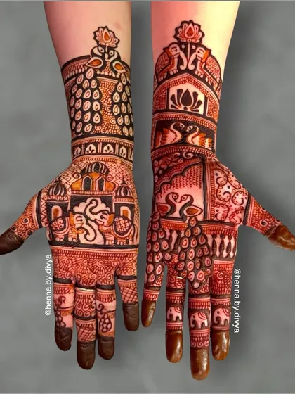 A mirror-image bridal design with a modern twist. The palms feature abstract swan and elephant figures, while the arms have peacock feather patterns and lotus motifs at the top.