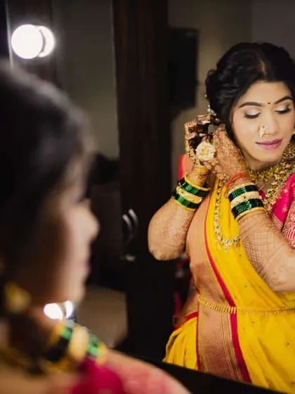 A bride in the spotlight, getting her final touches. The makeup is designed to look stunning under all lighting conditions.