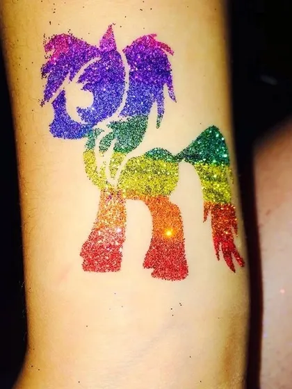 A rainbow-colored My Little Pony glitter tattoo. The vibrant colors make this design especially fun and eye-catching.