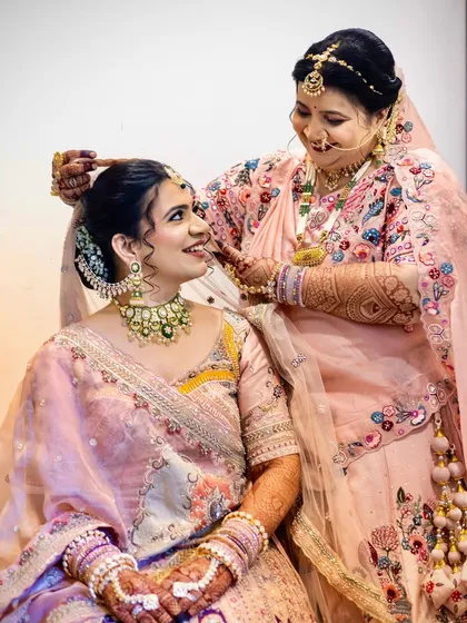 A sweet moment between the bride and her mother, who is helping her get ready.