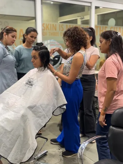 Our founder, Shine Janarthanan, demonstrating a haircut to a group of students, ensuring they understand every step of the process.