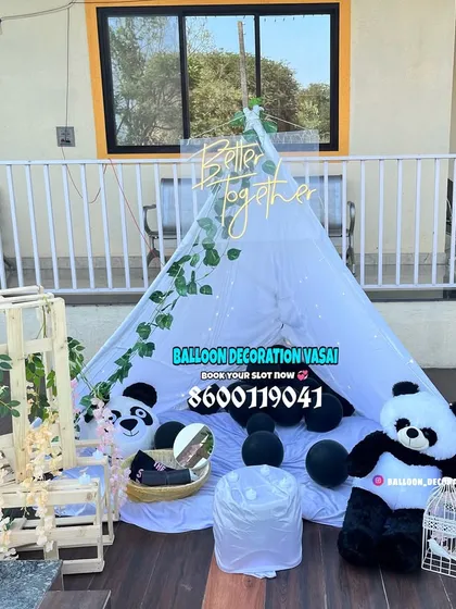 A cute and whimsical tent decoration set up on a balcony. This outdoor setup features a white canopy tent, panda plushies, and a "Better together" sign, perfect for a unique date or anniversary surprise.