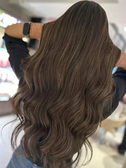 A classic highlight blend in caramel blonde on very long hair. This look is timeless and adds beautiful warmth and dimension.