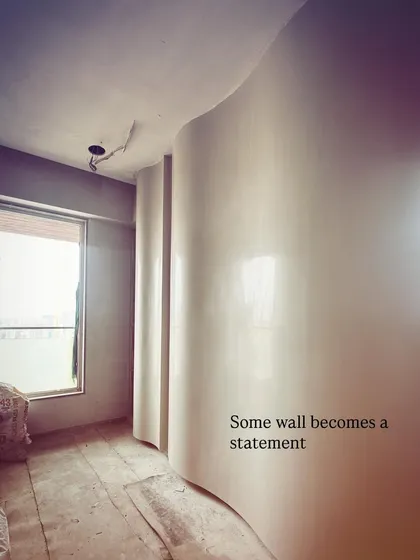 Sometimes a simple wall can become the main statement piece. Here, a curved wall is being finished with a special plaster technique to create a soft, sculptural element that guides you through the space.