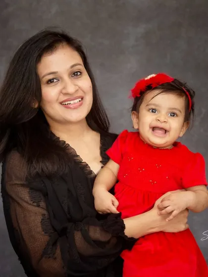 The pure happiness on this baby's face is everything. This mother and daughter portrait from a studio session captures a moment of pure, infectious joy.