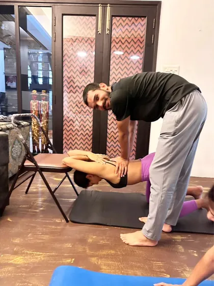A smiling student during a shoulder-opening stretch. My goal is to make the practice challenging yet enjoyable.