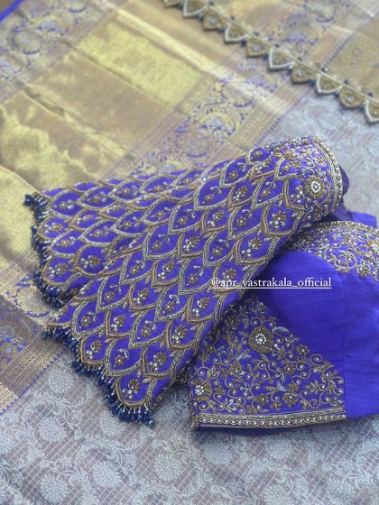 The sleeves of the purple blouse, showing the scale-like feather pattern.