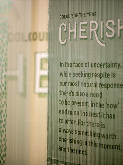A detail from the 'Cherish' installation, where the theme is printed on a translucent fabric panel. This demonstrates our focus on integrating the narrative directly into the material palette of our experiential designs.