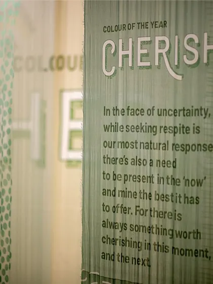 A detail from the 'Cherish' installation, where the theme is printed on a translucent fabric panel. This demonstrates our focus on integrating the narrative directly into the material palette of our experiential designs.