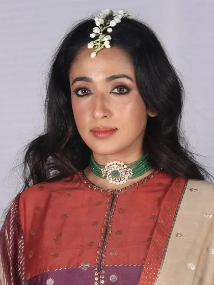 Another beautiful runway look from Bombay Times Fashion Week, featuring defined eyes and a delicate floral hairpiece. Our team excels at creating looks that complement the designer's vision.