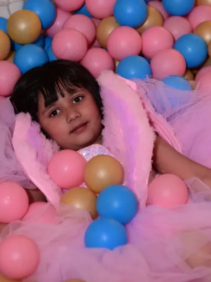 A birthday princess enjoying our colorful ball pit. It's one of the most popular spots in our playzone for kids of all ages.