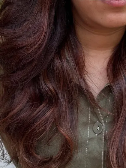 A 'Rose Gold' dream come true. We transformed her faded highlights into this stunning metallic pink shade. It’s a trendy yet sophisticated way to play with color.