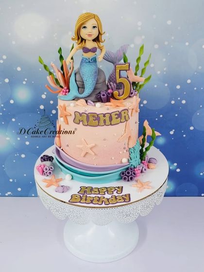 A studio shot of the single-tier mermaid cake for Meher, featuring a hand-sculpted mermaid, coral, and starfish.