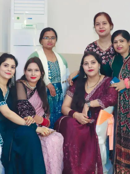 A group of female guests dressed in elegant sarees and suits pose for a photo. We document the guests and the festive fashion at your event.