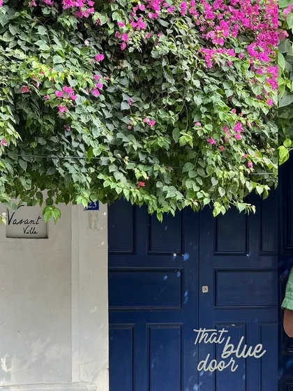 A beautiful blue door in Pondicherry, framed by lush pink bougainvillea. A simple yet stunning composition.