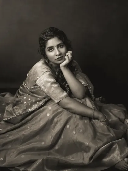 Vennela's portrait in black and white emphasizes the beautiful texture and drape of her saree. Her seated pose is both grounded and graceful, and the monochrome edit gives the image a timeless, sculptural quality.