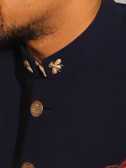 A closer look at the bee embroidery on the collar, a subtle yet meaningful detail that adds personality to the bespoke garment.
