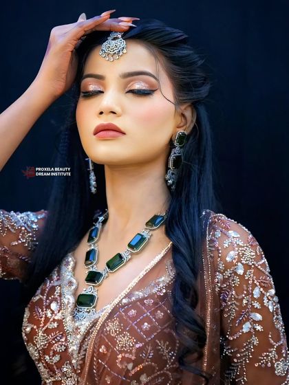 Eyes closed, feeling the glam. This shot highlights the shimmering eyeshadow and the soft texture of the wavy hairstyle, a perfect combination for a sangeet or cocktail night.