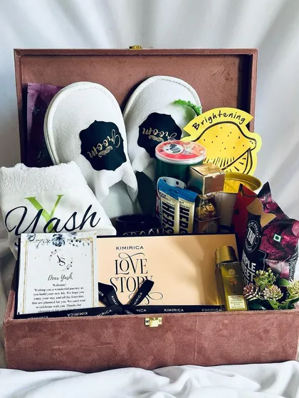 A bespoke hamper designed exclusively for the groom. This elegant box includes personalized "Groom" slippers, a custom-monogrammed towel, fine chocolates, and grooming essentials to ensure he feels just as special.