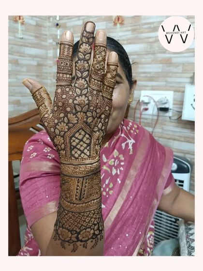 A lovely design for a wedding guest, with a happy client in the background.