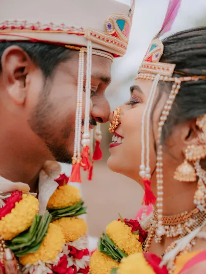 An intimate close-up during a traditional Maharashtrian wedding. I focus on the small, meaningful gestures and expressions that tell the deeper story of your wedding day, like this moment of connection between the bride and groom.