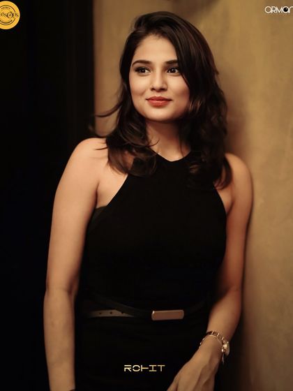 A guest posing in the warm, ambient light of Watsons, Kochi.