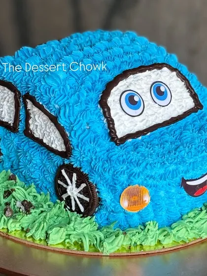 A fun 3D car cake, sculpted and decorated with blue buttercream. This chocolate mousse cake is perfect for a little one who loves cars.