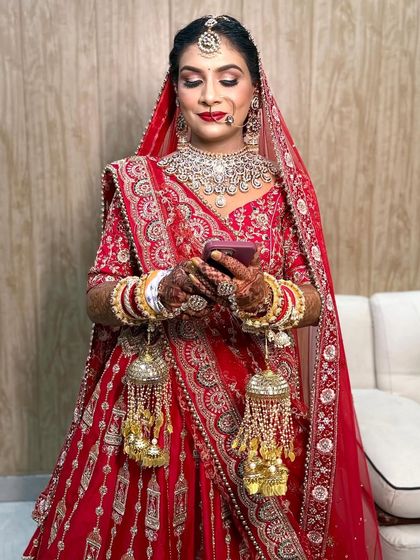 She is so beautiful. A candid moment of the bride checking her phone, looking absolutely perfect.