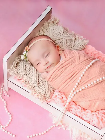 A peaceful portrait of the baby sleeping in the tiny bed, a perfect keepsake of how small they once were.