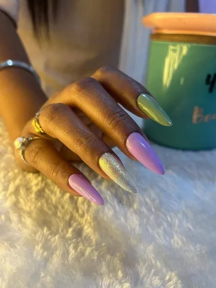 Soft gel extensions in beautiful pastel tones. This client chose a mix of lilac, green, and a shimmery yellow.