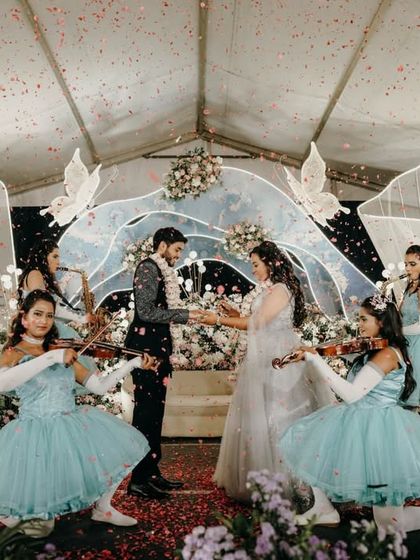 A fairytale ring ceremony, with the couple surrounded by performers dressed as angels with violins.