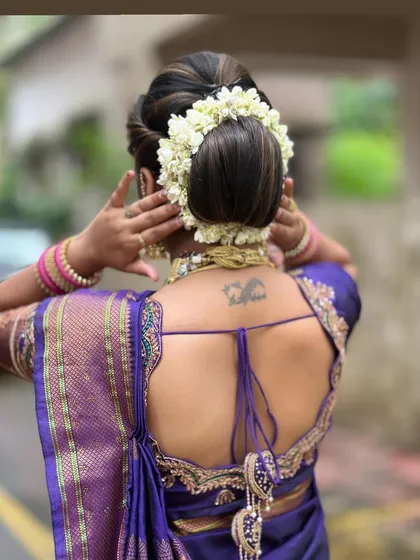 A view of the traditional bridal bun adorned with a gajra, a classic hairstyle we teach for wedding looks.