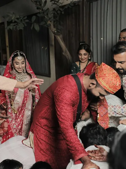 A candid moment of joy and tradition. The bride's smile is infectious, and her makeup looks fresh and radiant throughout the long ceremony.