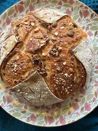 A rustic, multi-seed sourdough loaf, appealing to health-conscious foodies who visit our exhibitions.