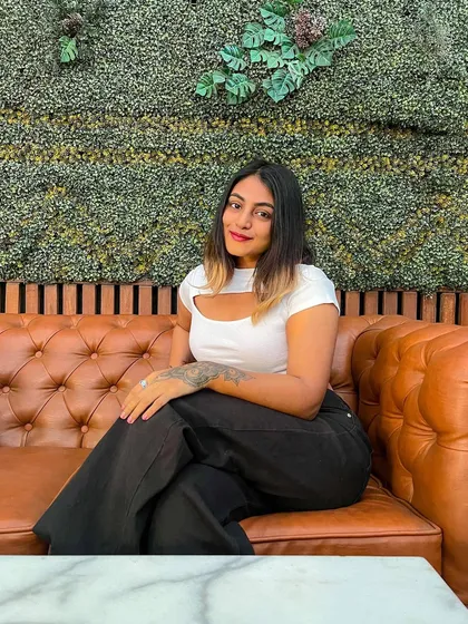 A smiling shot in my casual cheat day outfit. The combination of a white top and black pants is a timeless classic.